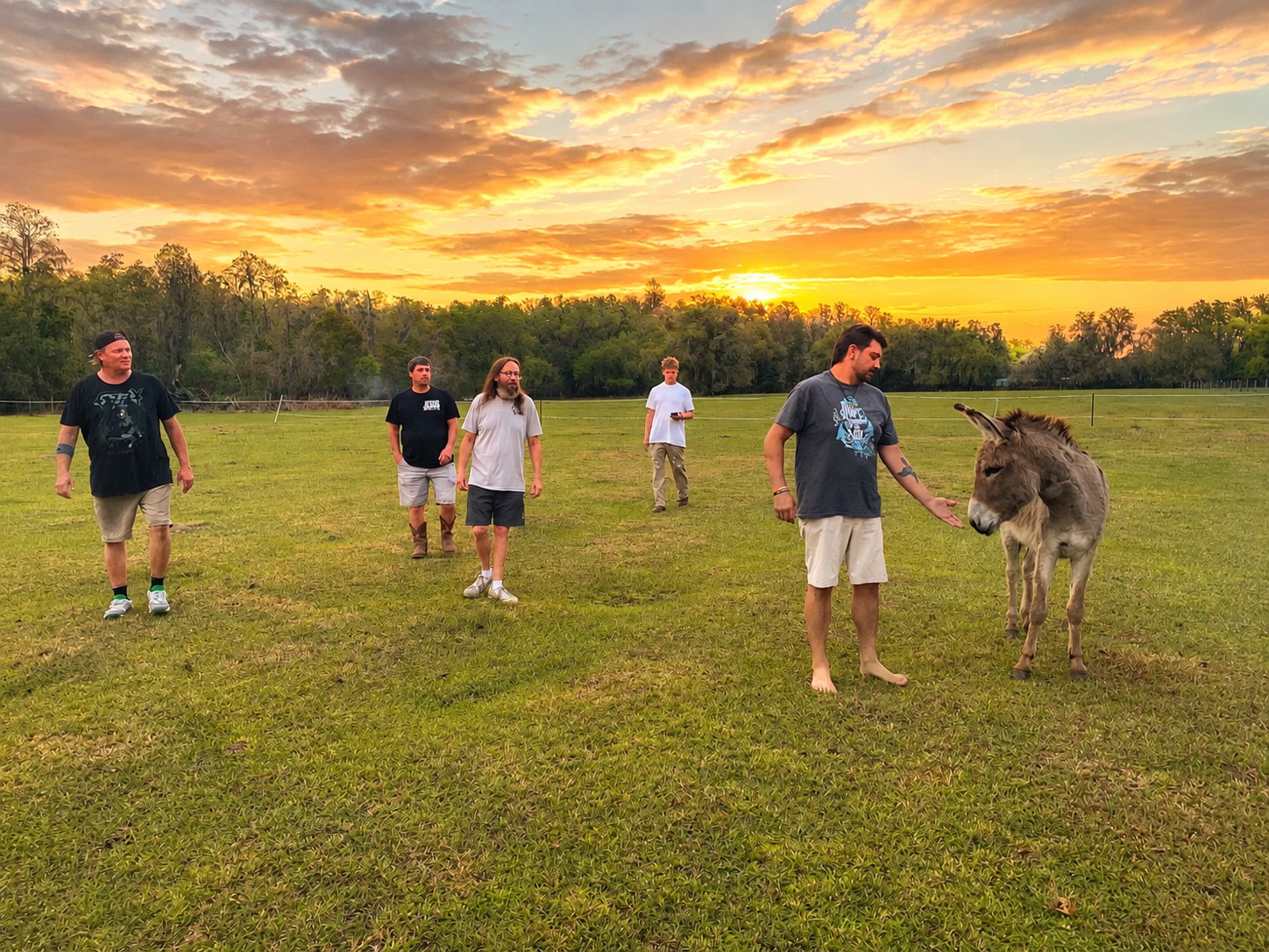 Men at Restored Farm with donkey at sunset